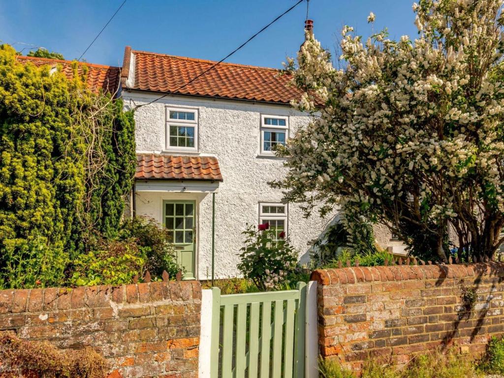 a white fence in front of a white house at 2 Bed in Lowestoft oc-88109 in Lowestoft