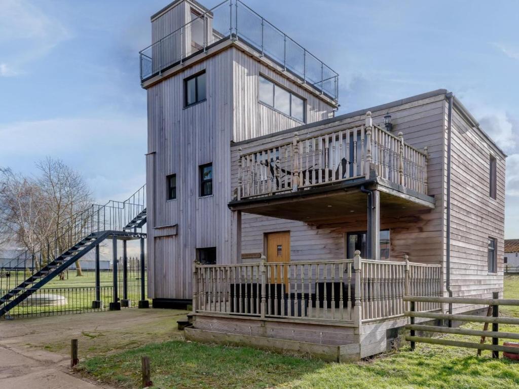 an apartment building with a staircase and a house at 3 Bed in Dereham oc-65903 in Foulsham