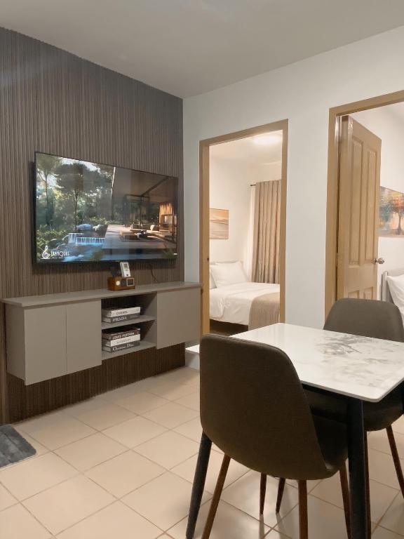 a living room with a table and a tv at AJA Suite in Davao City