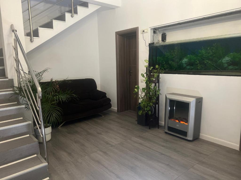 a living room with a fireplace and a couch at Bucharest Center Villa by ACME RENT in Bucharest