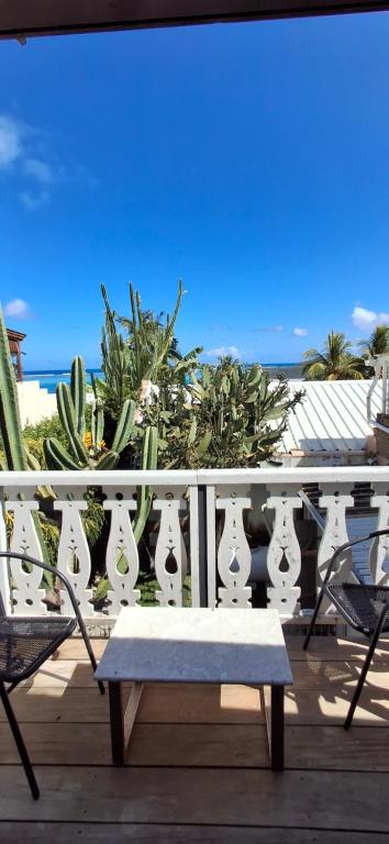 a white railing with a bench on a deck at Mermaid Cove - Blue Bay in Blue Bay