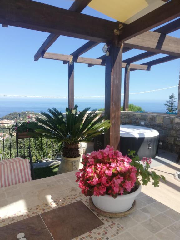 a patio with a tub and flowers on a table at Casa Olimpia - Mareri apartments in Poggi