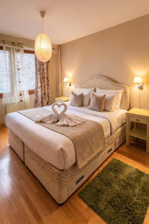 a bedroom with a large bed with two hearts on it at Sim apartment in Skopje in Skopje