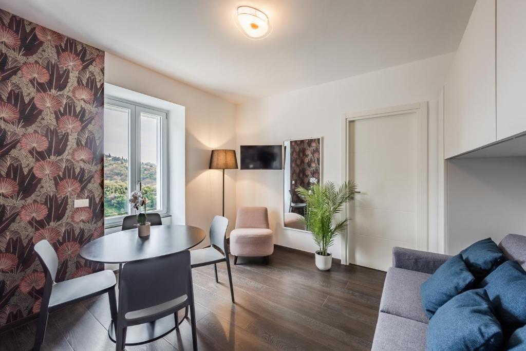 a living room with a table and a couch at Rapallo - Monolocale con piscina in Rapallo