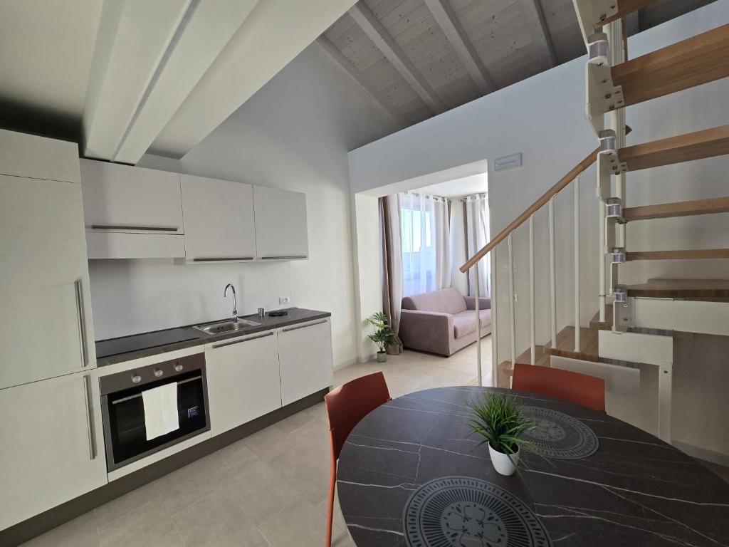 a kitchen and dining room with a table and chairs at Salionze Apartments in Salionze