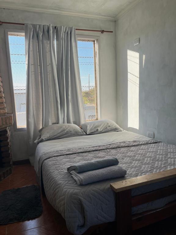 a bedroom with a bed with two towels on it at El quincho in San Pedro