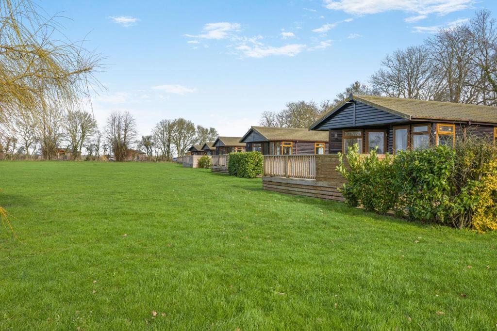 a home with a large yard in front of a house at Athelington lodge - Beech in Eye