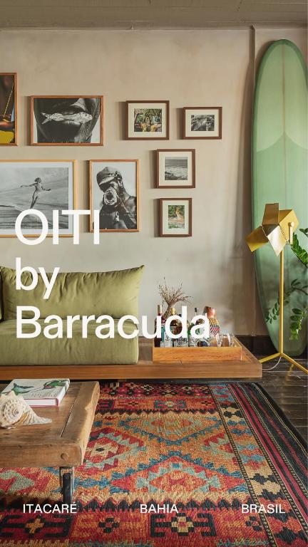 a living room with a table and a surfboard at OITI by Barracuda in Itacaré