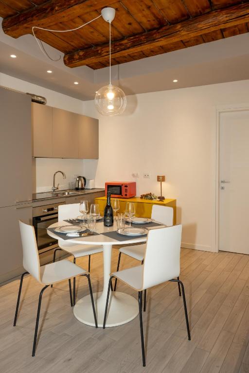 a kitchen and dining room with a table and chairs at Dimora del Borgo in Lovere