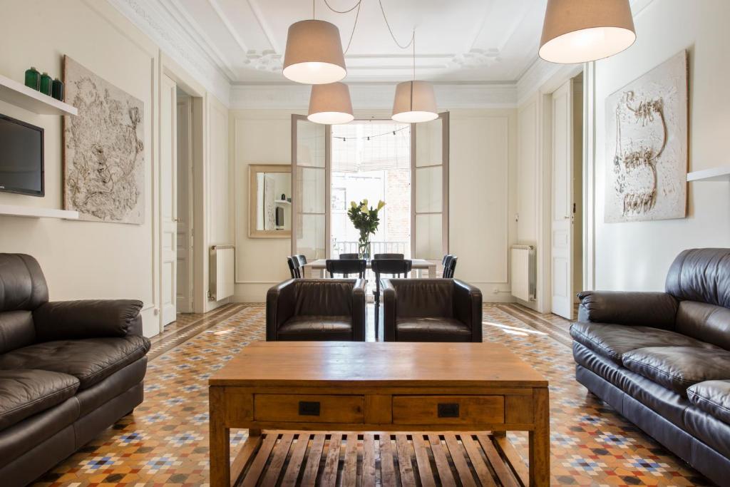 a living room with leather furniture and a table at SibsBcn- Rambla- Family Friends Business Central in Barcelona
