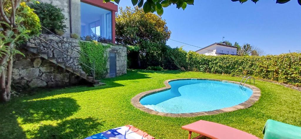 a small swimming pool in the yard of a house at Bean House in Vila Nova de Cerveira