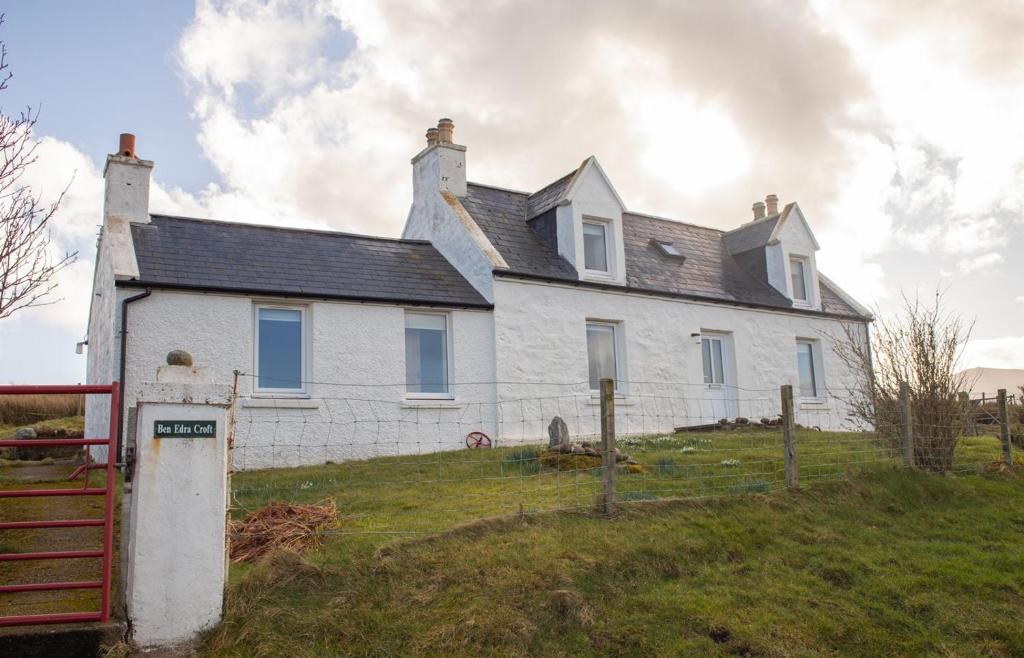 a white house on top of a hill at Ben Edra Croft in Staffin