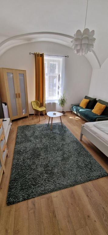 a living room with a couch and a rug at GOLD 3 in Sopron
