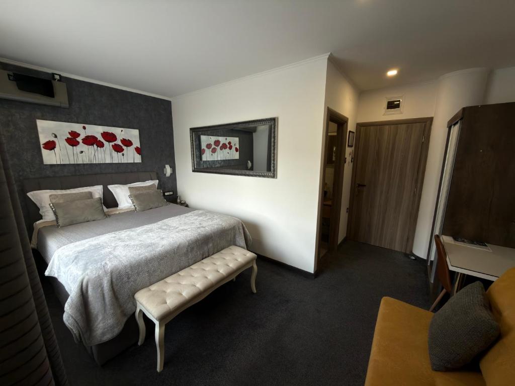 a hotel room with a bed and a couch at Luxury rooms Lira in Ogulin