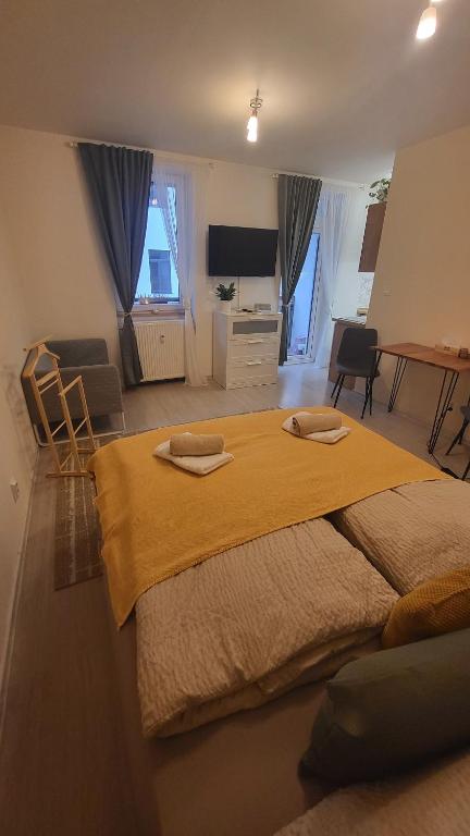 a bedroom with a large bed with two towels on it at Downtown Boho Botanico in Brno