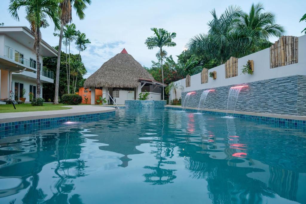 a swimming pool in front of a villa at Bambu Beach Haus Coronado in Las Lajas