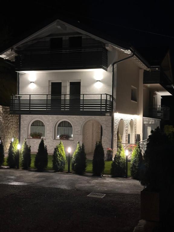 a large house with a balcony at night at Al Piz - Dimora Alpina in Pellizzano
