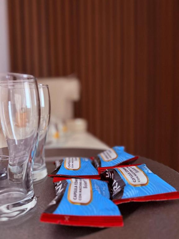 a table with two empty glasses and blue napkins at Ama Suite Romantic Spa in Bologna