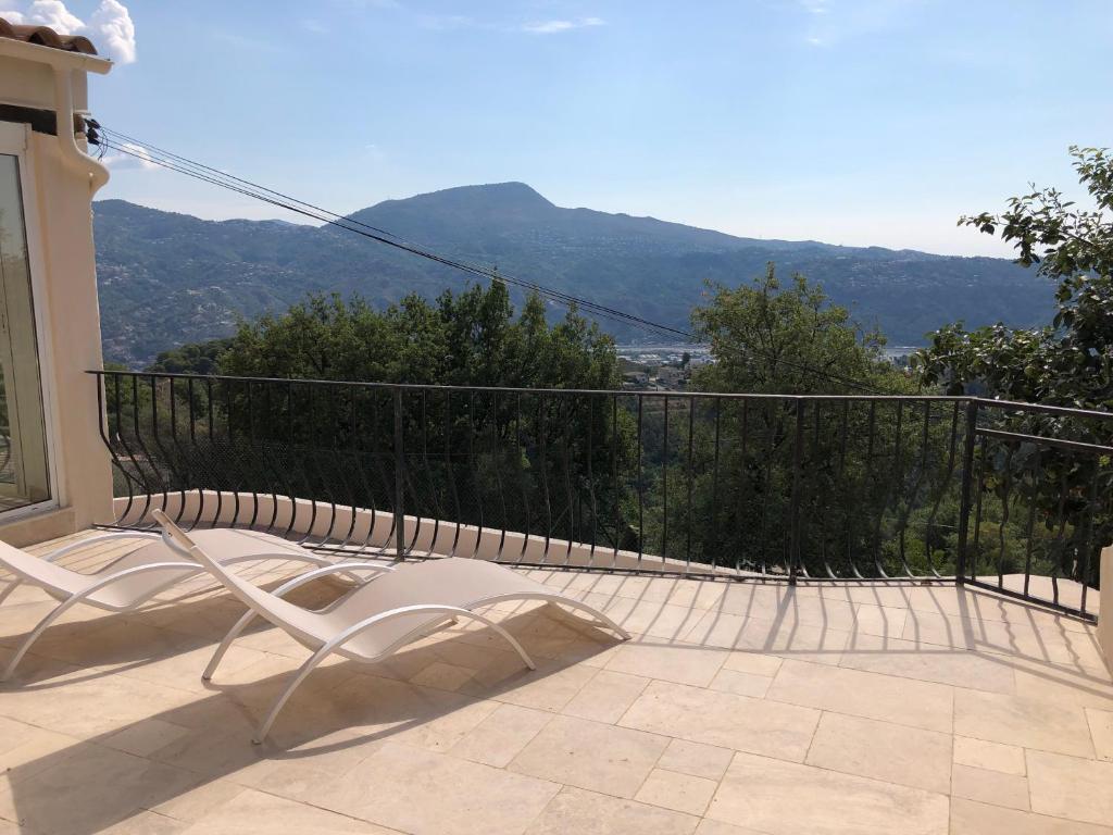 a white chair on a balcony with mountains in the background at French Riviera near Nice Monaco, Apartments in Villa, Sea Montain View in Carros