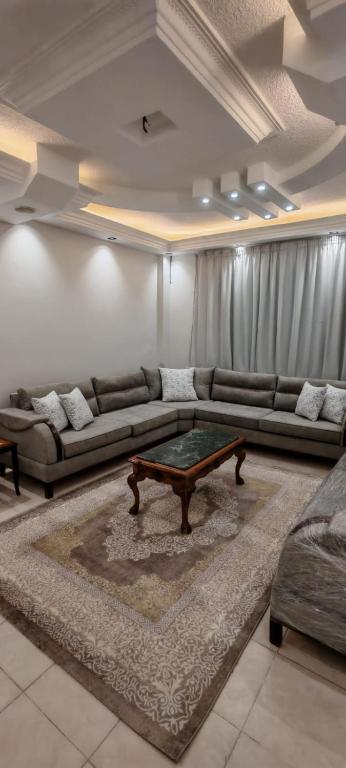 a living room with a couch and a table at cozy home in Jerash