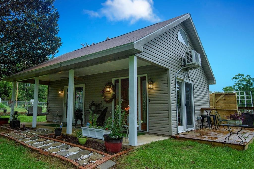 a small house with a porch and a patio at Nita's Nest in Foley