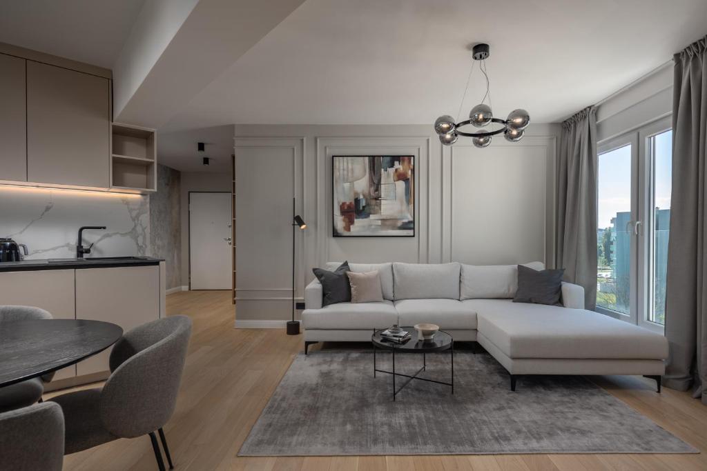 a living room with a white couch and a table at Iman Apartments in Zagreb