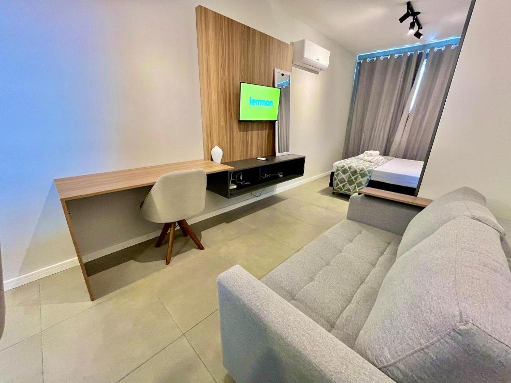 a living room with a couch and a tv at Loft near Santa Casa - Apt 604 in Porto Alegre