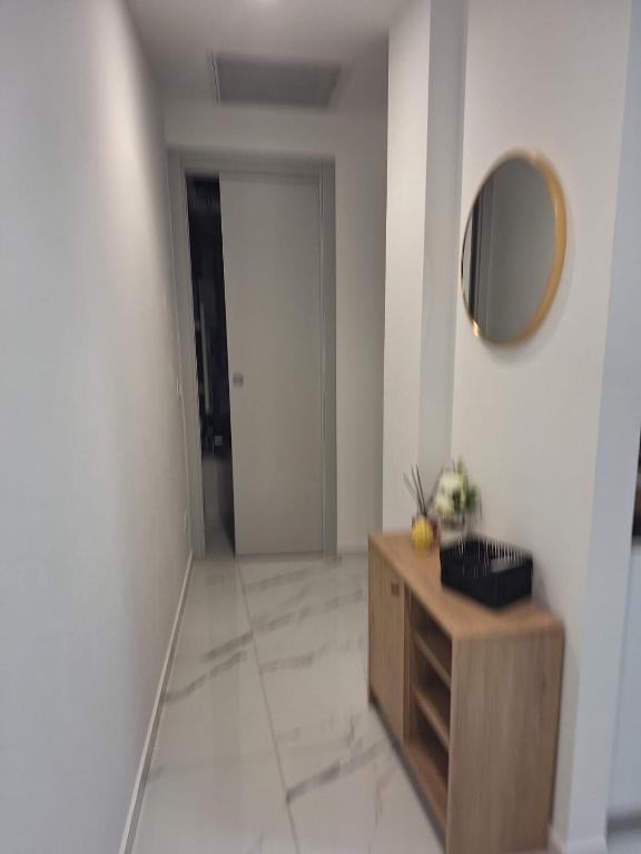 a hallway with a mirror and a wooden dresser at Delizioso bilocale Paolo in Alassio
