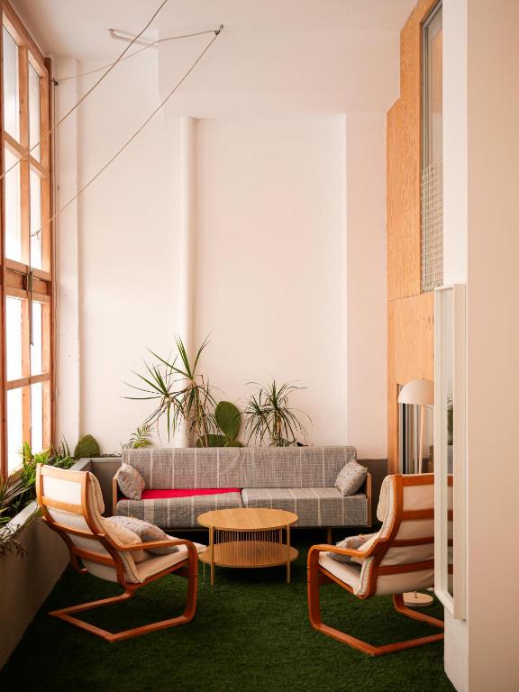 a living room with a couch and two chairs at The Grand Garden Loft in Pamplona