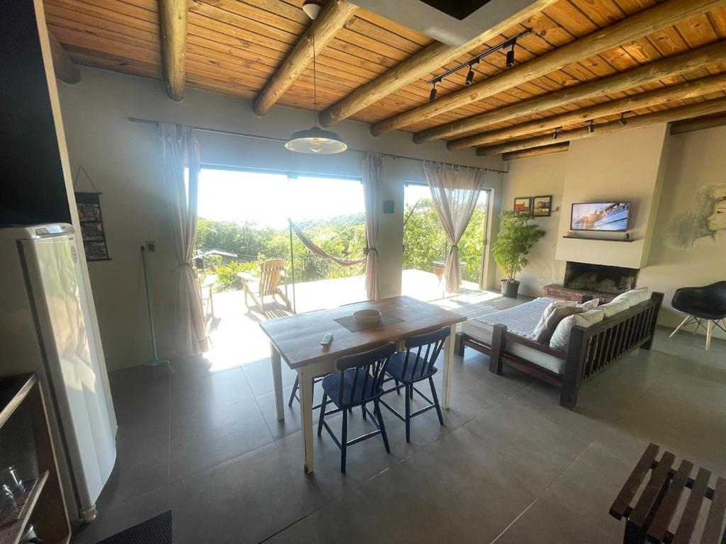 a living room with a table and a couch at Casa Morro da Borússia in Osório