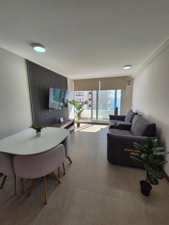 a living room with a couch and a table at Apartment in Playa Brava Ocean View & SmartLock in Iquique
