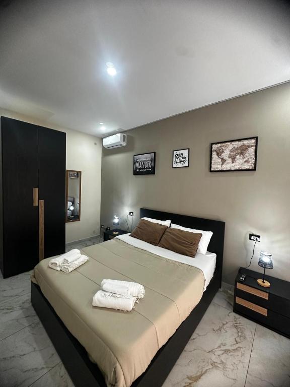 a bedroom with a large bed with towels on it at Little Dreams in Caserta
