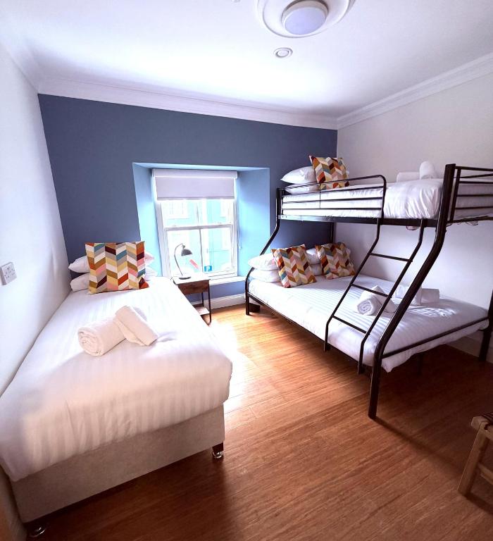 a room with two bunk beds and a window at Westport Rooms in Westport