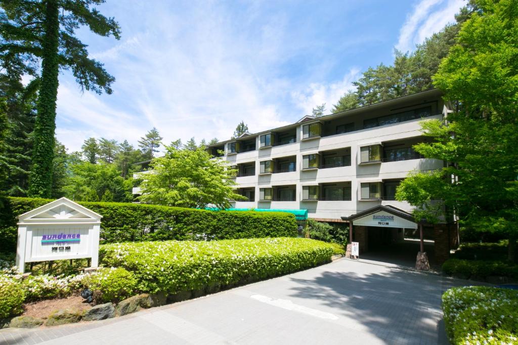 a building with a hedge in front of it at Sundance Resort Kawaguchiko in Fujikawaguchiko