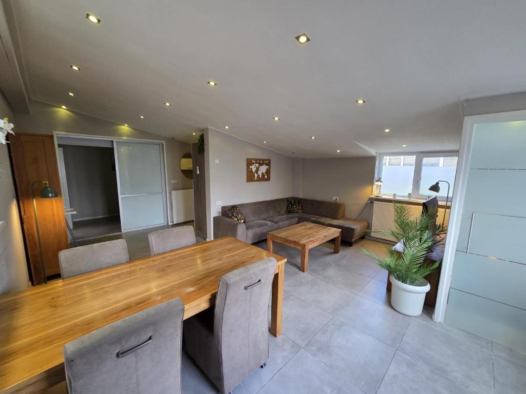 a living room with a wooden table and a couch at Dorpsdijk 53A in Vrouwenpolder