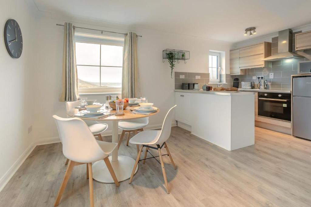a kitchen with a table and chairs in a room at 2 Bed in Woolacombe oc-beache in Woolacombe