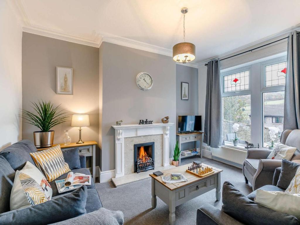 a living room with a couch and a fireplace at 4 Bed in Holmfirth oc-86032 in Holmfirth