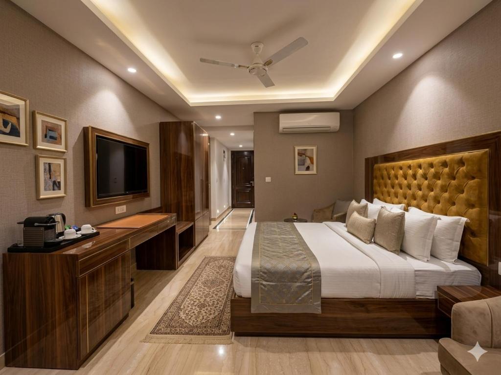 a hotel room with a bed and a television at Hotel Grand Loft Near IGI Airport New Delhi in Pilwa