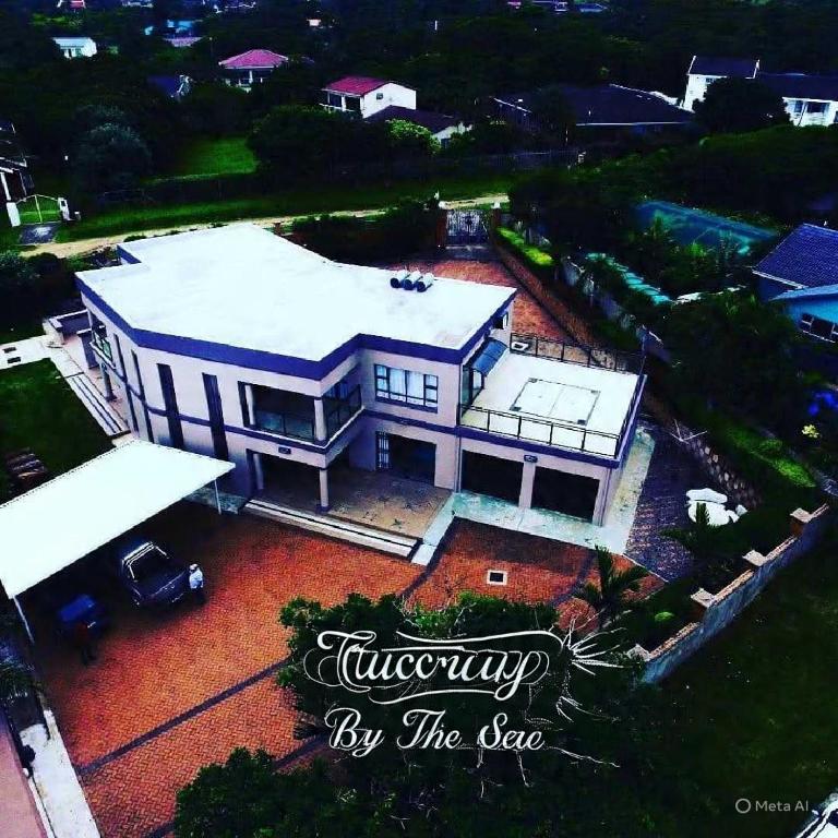 an aerial view of a large white house at Tuscany By The Sea in Port Edward