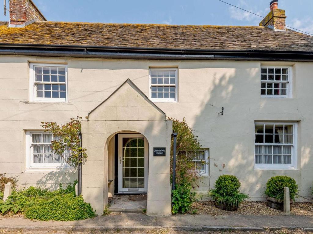 a white house with a door in front of it at 5 Bed in Wareham oc-dc032 in West Lulworth