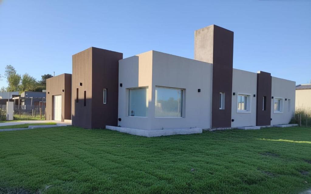 a house with a lawn in front of it at Villa Pi in Miramar