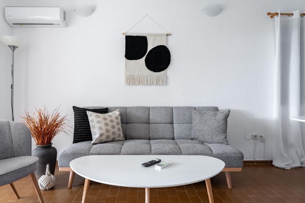 a living room with a couch and a coffee table at Saronida Coastal Escape 2BR Apartment in Saronida