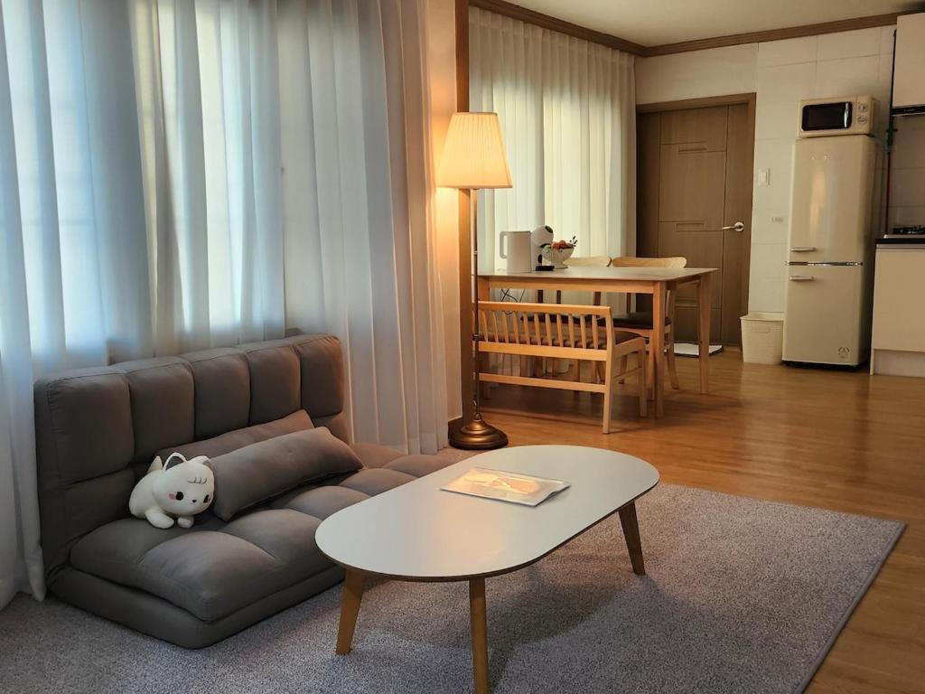 a living room with a couch and a table at Gaegum Moonlight Stay in Busan