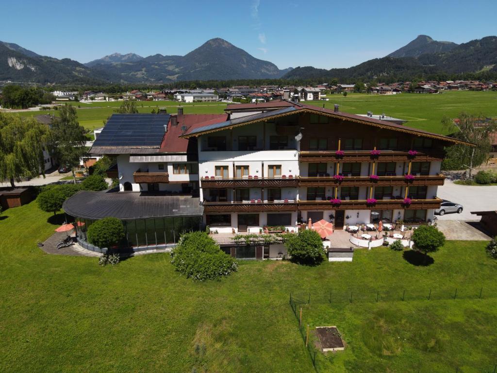 an aerial view of a hotel with mountains in the background at dasKAISER - Dein Gartenhotel in Tirol in Ebbs