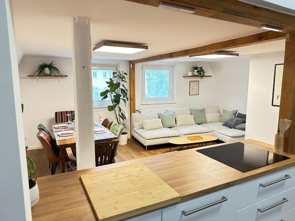 a kitchen and living room with a couch and a table at Altstadt Appartement in Ingolstadt