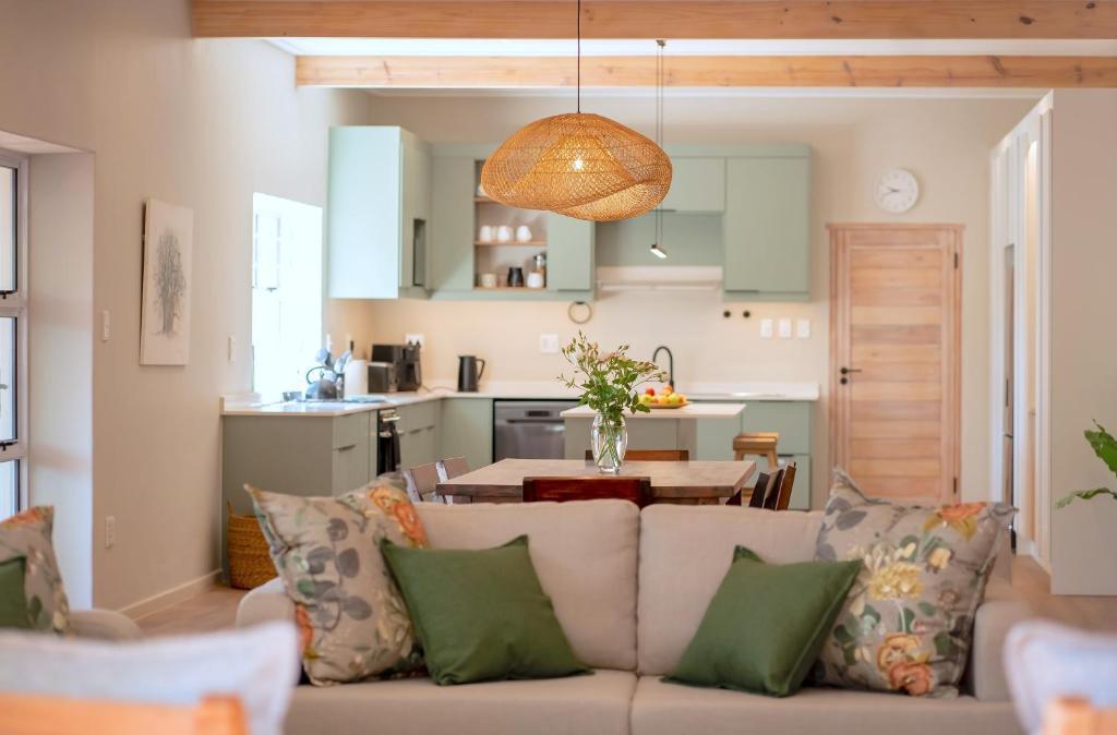 a living room with a couch and a kitchen at Scandi House in Louis Trichardt