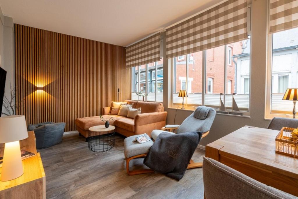 a living room with a couch and chairs and a table at Pier17 Appartement 2 in Borkum
