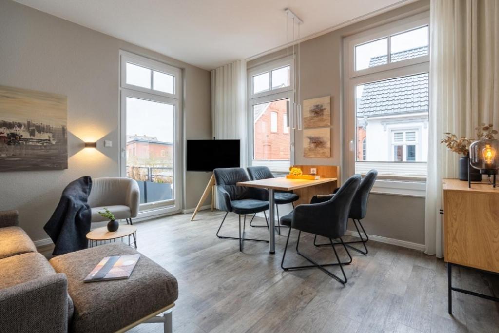 a living room with a couch and a table at Pier17 Appartement 5 in Borkum