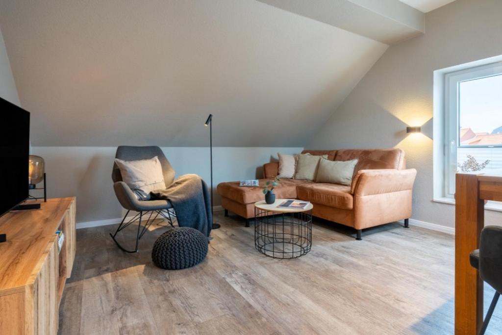 a living room with a couch and two chairs at Pier17 Appartement 6 in Borkum