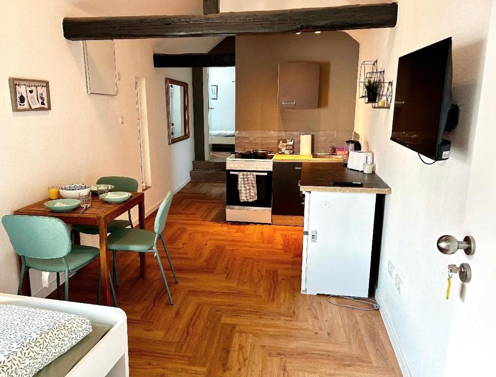 a kitchen with a table and a kitchen with a dining room at modernes Apartment mit Wlan in Lorsch